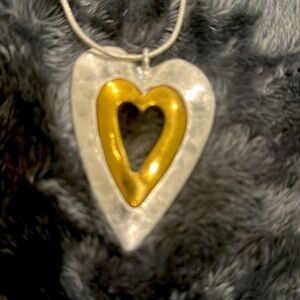 Silver necklace with a silver/gold heart w extra long chain.